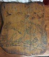 Front view of wooden etched art featuring a wolf and birds with signature "Keith '79".