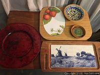 Photo showing all items in lot: two cutting boards, two pottery bowls, large red glass plate