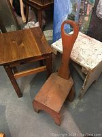Wooden small table or stool with four legs and sturdy construction