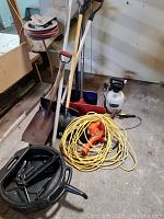Image showing garden sprayer, oil pan, grease gun, extension cord, electric hedge trimmer, and multiple snow shovels