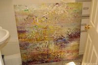 Full view of the large abstract oil painting on canvas leaning against a wall, showing multiple colors and textures.