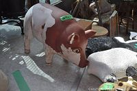 Photo of large painted metal pig garden statue showing some paint wear