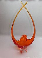 Full view of the tall vintage orange chalet glass vase, showing overall shape and color