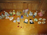 Overview of porcelain figurines and decorative items arranged on a wooden surface