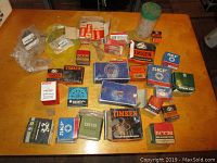 Overview photo showing an assortment of bearings and automotive parts in original boxes and plastic bags laid out on a table.