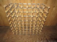 Front view of wooden wine rack showing 64 bottle slots