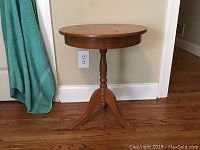 Photo of round wooden side table showing design and finish