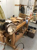 Overhead view of workbench top showing wood blocks, chisel storage and buffing wheel
