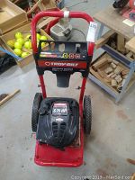 Front view of Troy-Bilt pressure washer showing 6.75 HP engine and control panel with wheeled red frame.