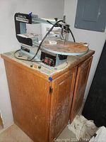 Overall view of the Delta scroll saw mounted on wooden cabinet