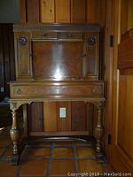 Front elevation view of entire desk showing drop-front closed and drawer configuration