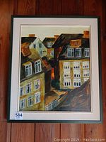 Framed acrylic painting showing rooftops and windows of buildings with dominant black, brown and cream colors.