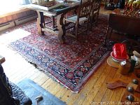 full view of rug under dining table showing overall pattern and wear