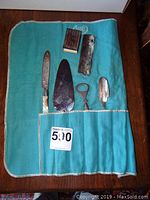 All items laid in teal cloth roll showing contents