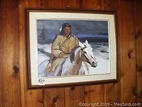 Frontal view of entire framed painting hung on wood-paneled wall showing the full scene of man on horse.