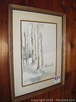 Framed watercolor painting showing a group of birch trees in neutral tones framed under glass with a beige mat and gold frame.