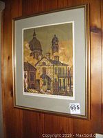 Full view of the framed print hanging on wood wall.