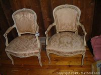 Pair of two matching occasional chairs with upholstered beige damask patterned fabric and white distressed carved wooden frames