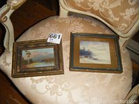 Two mini oil paintings on a patterned chair, showing size and overall appearance