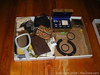 Overview photo showing jewelry boxes, handbags, jewelry pieces, hand mirror, and a brown book/journal.