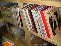 Shelf of vintage vinyl records mostly 33 rpm in album sleeves
