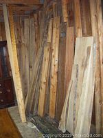 Various rough sawn boards leaning against exposed wall studs