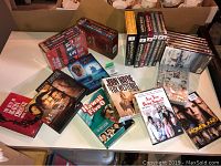 Photo showing various DVD boxes and sets laid out on a table, including John Wayne Fox Westerns and TV series DVDs