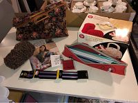 Full view of yarn, crochet hooks, bags, and boxed electric yarn ball winder