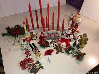 Wide view of all vintage Christmas decorations arranged on a white surface to show lot contents