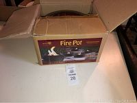 Box of Green Earth Fire Pot showing product image and branding