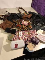 Photo showing full assortment of Fossil purses, wallets, and various small handbags including brown leather crossbody and colorful patchwork bag