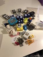Multiple craft punches with different shapes and colors arranged on a surface.