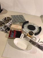 Overview of all items including knives, pet bowls, glass tray, wall clock, and dog figurines.