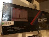 Box showing the metal goal with red frame and listed specifications.