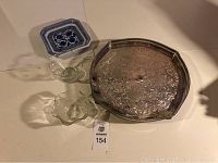 Image showing large ornate vintage silver-plated tray, two clear glass bowls, and small blue patterned dish.