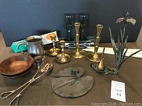 Full view of lot items including sundial, candlesticks, bowls, glasses, and sculpture.
