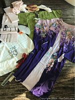 Full set including kimono, green dress, pink obi, traditional shoes, and accessories displayed on dark floor