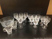 Full view of six 6.25 x 2.75 wines, six 4.75 x 2.75 wines, five Fosteria cordial glasses, sugar and creamer set, and crystal bowl on display