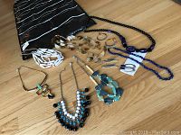 View of all jewelry including necklaces, earrings, and hanging organizer showing assortment and layout.