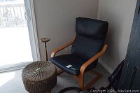 Overall view of armchair, ottoman, candlestick