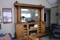 Front view of entire oak buffet/bar with attached mirror