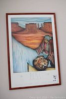 Framed Pena print from Adagio Gallery Palm Springs depicting a native person holding pottery with Southwest landscape background