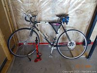 Left side view of bicycle on stand with pump