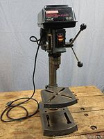 Full view of the Craftsman 8-inch drill press showing the stand, work table, and drill head including handles and power cord.