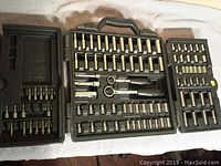 Open view of the full disassembled socket set showing ratchets, sockets, and driver bits in molded case.