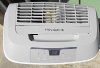 Top view of Frigidaire dehumidifier showing brand logo, air vent, and digital control panel displaying numbers and buttons.