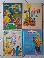 Four Sesame Street storybooks featuring various characters on the covers, including Big Bird, Grover, Ernie, and Elmo.