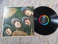 The Beatles vinyl album with visible Capitol Records label and album cover with four band members.