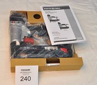 Brad nailer in original box with manual visible