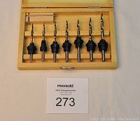 Full set of 7 countersink bits with adjustable collars in wooden storage box, arranged from smallest to largest size.
